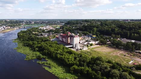 Kaunas-Grudai-factory-complex-on-Nemunas-river-coastline,-aerial-drone-view