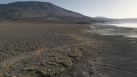 Drone-Aéreo-Sobre-Laguna-Colorada,-Humedal-De-Sedimentos-Marrones-En-La-Cordillera-Andina-Boliviana,-Cielo-Escénico-De-Madre-Tierra-No-Contaminada,-Maravilla-Natural