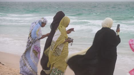 Einige-Muslimische-Afrikanerinnen-Genießen-Den-Strand-An-Einem-Windigen-Tag