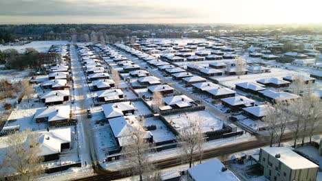 Luftaufnahme-Von-Häusern-In-Einer-Nachbarschaft,-Die-Im-Winter-Mit-Schnee-Bedeckt-Sind,-Bewölkter-Tag,-Aufnahme-Von-Oben,-Kamera-Zoomt-Hinein