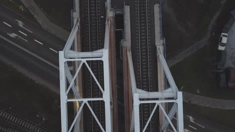 Top-down-slow-tracking-close-up-shot-of-train-tracks-on-a-bridge
