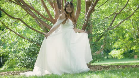 Beautiful-Latina-Bride-with-Stunning-Wedding-Dress-Reveal-Walking-near-Green-Trees