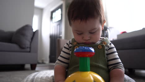 hispanic-latino-baby-with-toy-in-living-room