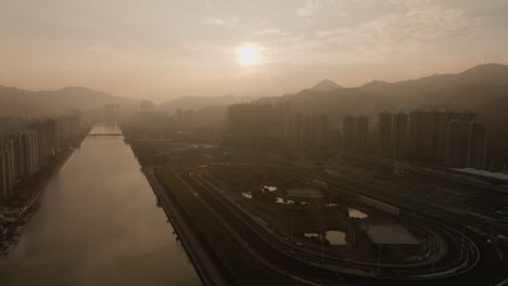 Hong-Kong-city-aerial-view-at-sunset-with-foggy-polluted-air-cause-of-traffic-cars-smog,-cityscape-skyline-of-modern-Chinese-metropolis