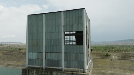Abandoned-desolate-sheet-metal-control-tower-in-Dali-Mta-reservoir