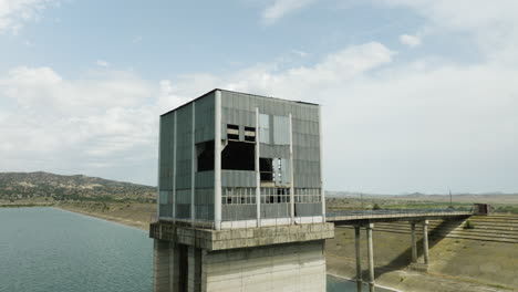Desolate-control-tower-and-bridge-to-dam-dyke,-Dalis-Mta-reservoir