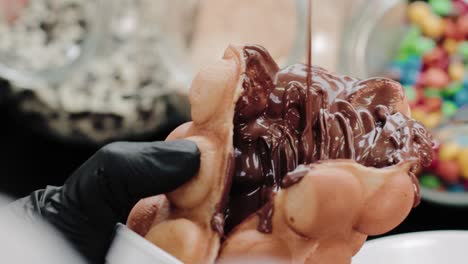 Pouring-melted-chocolate-on-a-waffle-in-a-candy-store
