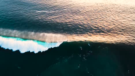 Aerial-view-of-wave-crashing-near-surfers-at-blacks-beach