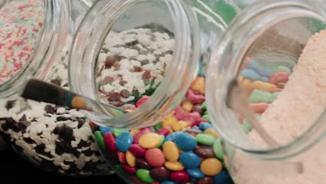 Candies-and-chocolate-sprinkles-in-jars-in-a-candy-store