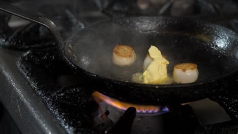 Chef-adds-butter-to-pan-with-scallops