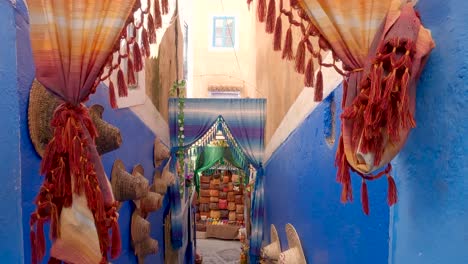 Walking-down-colorful-alleyway-towards-market-in-Chaouen-,-Morocco