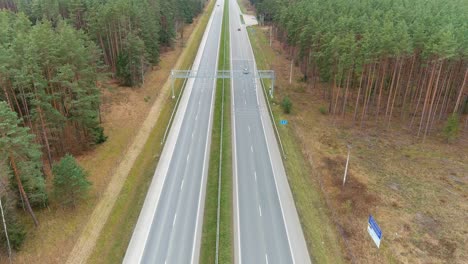 Highway-road-with-speed-monitoring-device,-aerial-drone-view