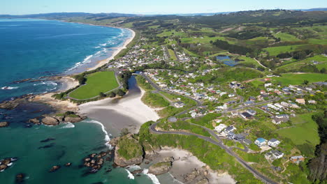 Establishing-Aerial,-Drone-view-of-shoreline-by-the-city-of-Brighton-in-New-Zealand