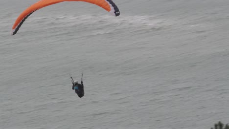 A-man-on-a-paraglider-flying-at-high-speed-above-sea-level