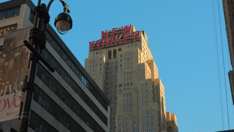 Looking-Up-On-The-Famous-The-New-Yorker-Hotel-Building-Against-Blue-Sky-In-Manhattan,-New-York-City