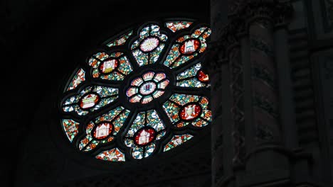 Revealing-shot-of-intricate-decorative-stained-glass-panes-in-a-church