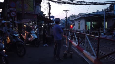 Saigon-to-Hanoi-trainlline-traveling-through-a-busy-Saigon-street-in-early-morning
