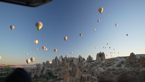 Aerial-View,-Parachutes-Above-Cappadocia-From-Hot-Air-Balloon-Basket-at-Sunrise