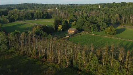 The-back-drone-view-of-the-Frame-house-and-barn-near-the-Joseph-Smith-family-farm,-temple,-visitors-center,-sacred-grove-in-Palmyra-New-York-Origin-locations-for-the-Mormons-and-the-book-of-Mormon