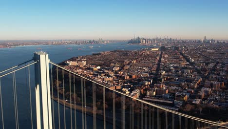 Aerial-view-over-the-Verrazzano-Narrows-bridge-towards-the-Fort-Hamilton-cityscape,-fall-in-Brooklyn,-NY,-USA