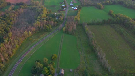 slow-drone-aerial-over-the-frame-house-and-road-near-the-Joseph-Smith-family-farm,-temple,-visitors-center,-sacred-grove-in-Palmyra-New-York-Origin-locations-for-the-Mormons-and-the-book-of-Mormon