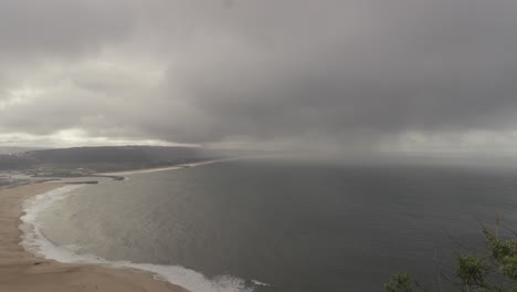 Nazare-beach-in-Portugal,-bad-cloudy-weather,-wide-angle-static-view