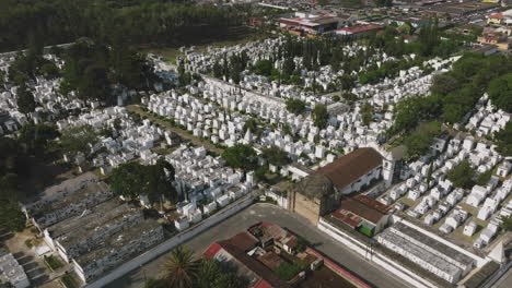 Slow-aerial-flyover-of-a-white-cemetery-in-Antigua,-Guatemala