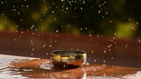 Water-Splashing-Splattered-Out-of-Steel-Bowl,-Slow-Motion-Outdoor-Shot-of-Object-Falling-in-Steel-Container-Causing-Fresh-Water-Splash-and-Splatter