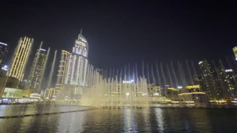 Wide-view-with-the-water-show-from-Dubai-fountain-seen-at-night-with-the-cityscape-as-a-background
