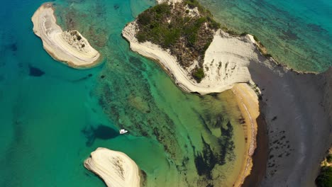 Stunning-aerial-footage-of-Cape-Drastis-in-Corfu,-Greece-showcasing-breathtaking-rock-formations-and-crystal-clear-Ionian-Sea