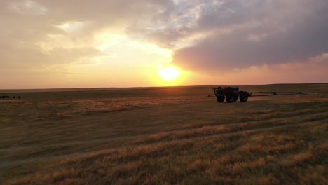 HORSCH-sprayer-tractor-spraying-farm-land---sunset-drone