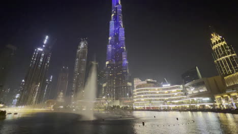 Slow-tilt-of-the-Burj-Khalifa-while-the-Dubai-fountain-show-is-performed