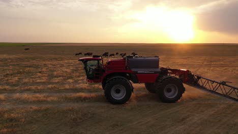 HORSCH-self-propelled-sprayer-tractor-spraying-farm-land-at-sunset