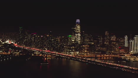 Aerial-slider-shot-of-San-Francisco-skyscrapers-from-the-bay-bridge-at-night