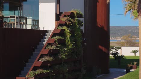 Revealing-shot-of-the-abstract-flower-beds-on-the-side-of-the-stairs-at-a-villa