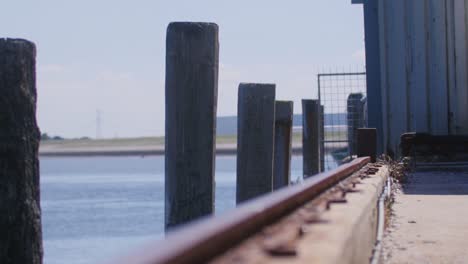 Amazing-shot-of-a-boat-dock-at-the-seaside-with-a-bird-flying-in-the-background-in-slowmotion