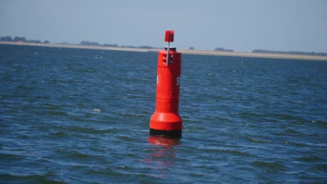 A-red-buoy-in-the-middle-of-the-sea-in-slowmotion