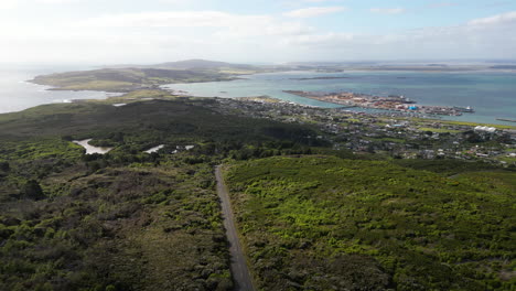 Aerial-panning-view-from-viewpoint-of-Bluff-with-green-area-and-sea