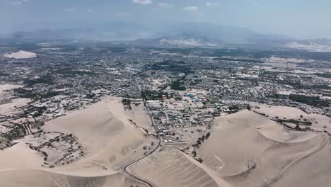 Desert-sand-dunes-and-city-town-of-Peru