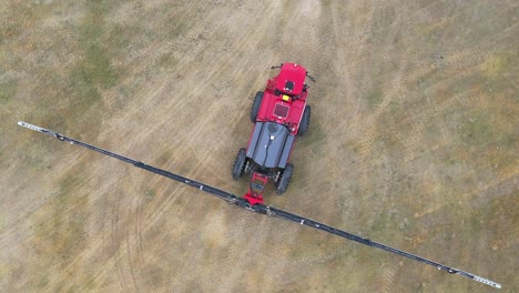 Red-sprayer-tractor-on-farm-land-ready-to-spray
