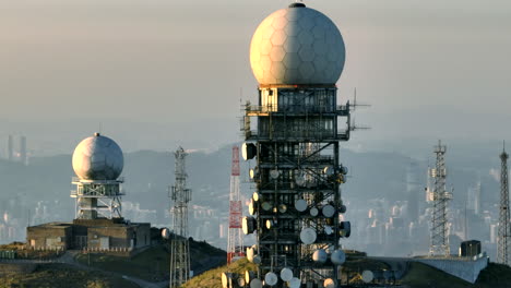 Aerial-orbit-shot-of-radome-on-top-of-Tai-Mo-Shan-in-Hong-Kong-at-sunset---Shenzhen-downtown-in-backdrop---Parallax