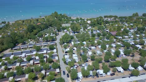 Rows-upon-rows-of-RV's-and-camper-vans-are-seen-next-to-an-Ocean-front-beach