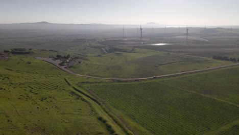Drone-flyover-view-of-farming-crops-and-wind-turbines,-Valley-of-Tears,-Israel