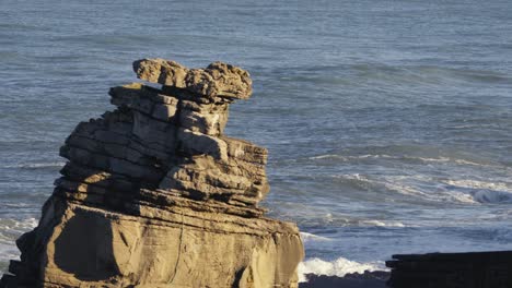 Cliffs-and-stone-layers-on-Peniche-Portugal-coast,-erosion-concept,-zoom-out