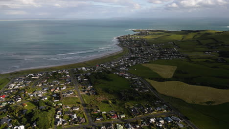 Drone-flight-over-Riverton-with-view-over-Hendersons-Bay,-New-Zealand