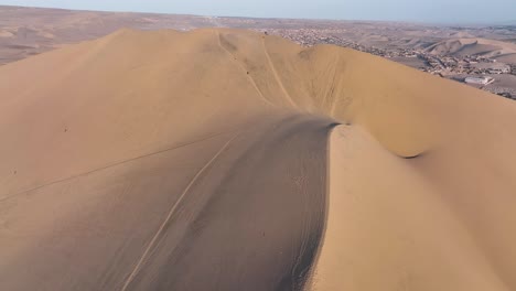 Desert-sand-dunes-and-city-town-of-Peru