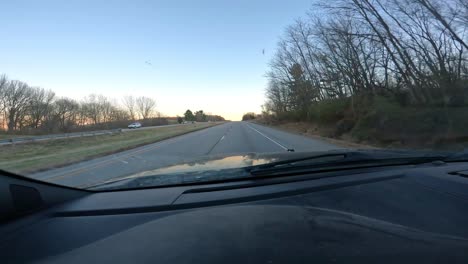 Point-of-view-through-the-front-window-while-driving-on-a-interstate-with-little-traffic