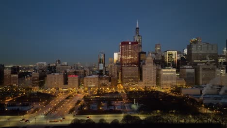 Aerial-tracking-view-from-Grant--to-the-Millennium-Park,-winter-dawn-in-Chicago,-USA