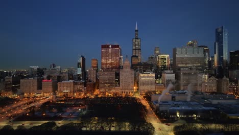 Aerial-view-of-the-Grant-park-and-the-Chicago-Loop-cityscape,-night-in-IL,-USA