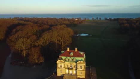 Sun-shining-on-iconic-hunting-lodge-building,-aerial-drone-view